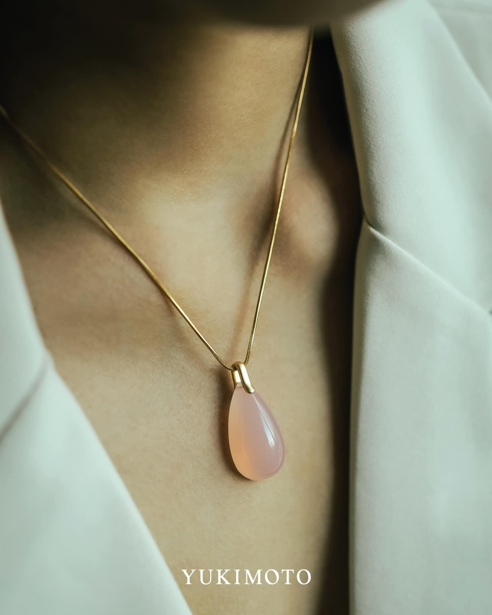 Close-up of Yukimoto Alaskan Rose Quartz Pendant worn on a delicate gold chain, showcasing elegance and natural beauty.