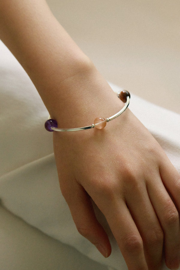Model wearing the 4Play Bangle showcasing luminous gemstones and sleek sterling silver design.