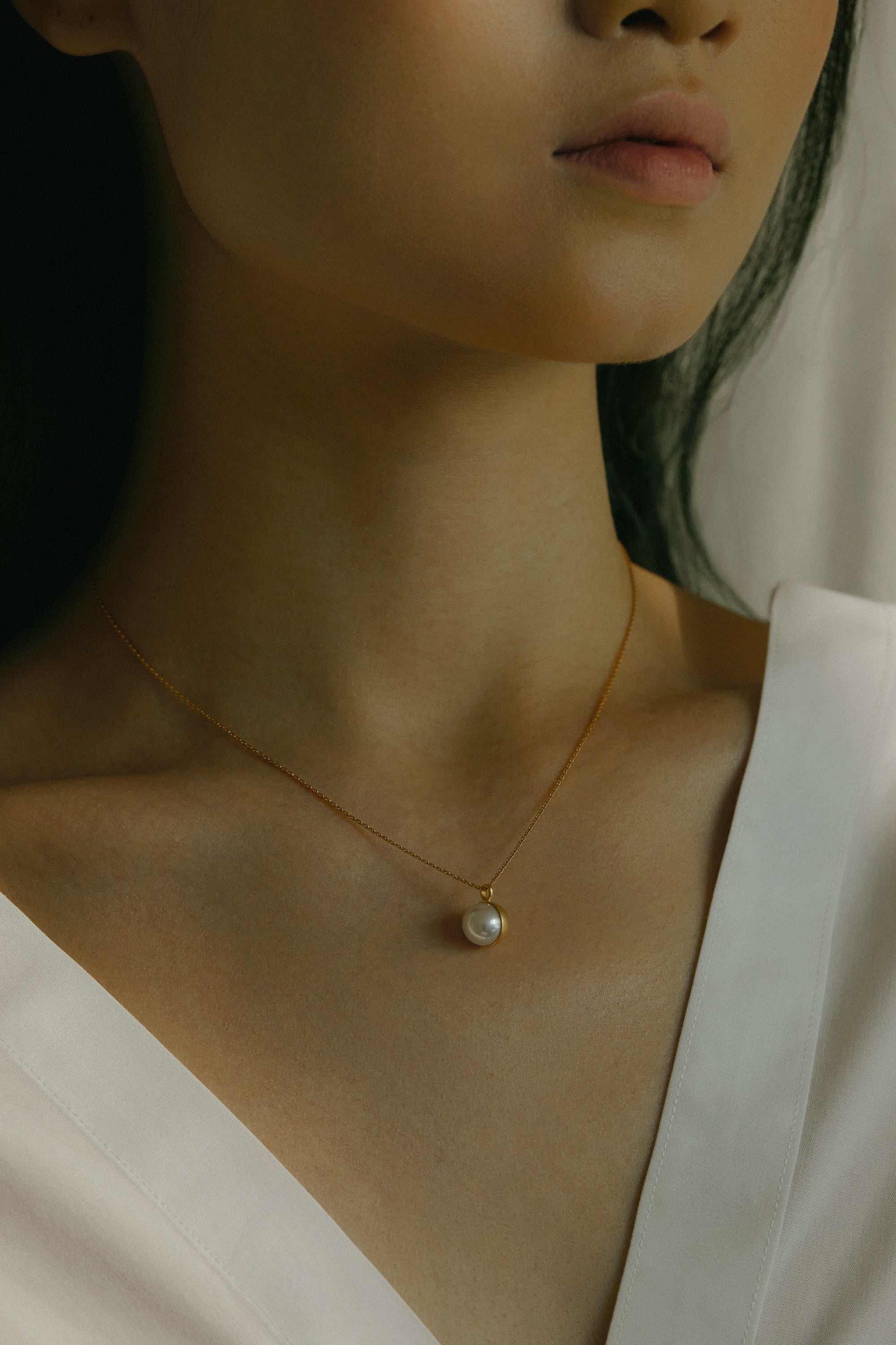 Yukimoto Bullet Pearls necklace featuring minimalist bullet design