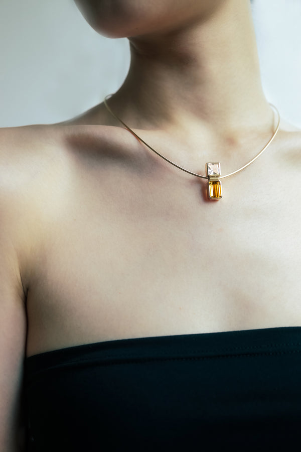 Elevé Yellow Emerald and Topaz pipe pendant on a model, showcasing elegant gem jewelry with 18k Gold accents.