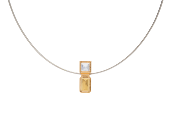 Elevé Yellow Emerald x Topaz pipe pendant with 18k gold detailing, featuring yellow emerald and clear topaz gemstones.