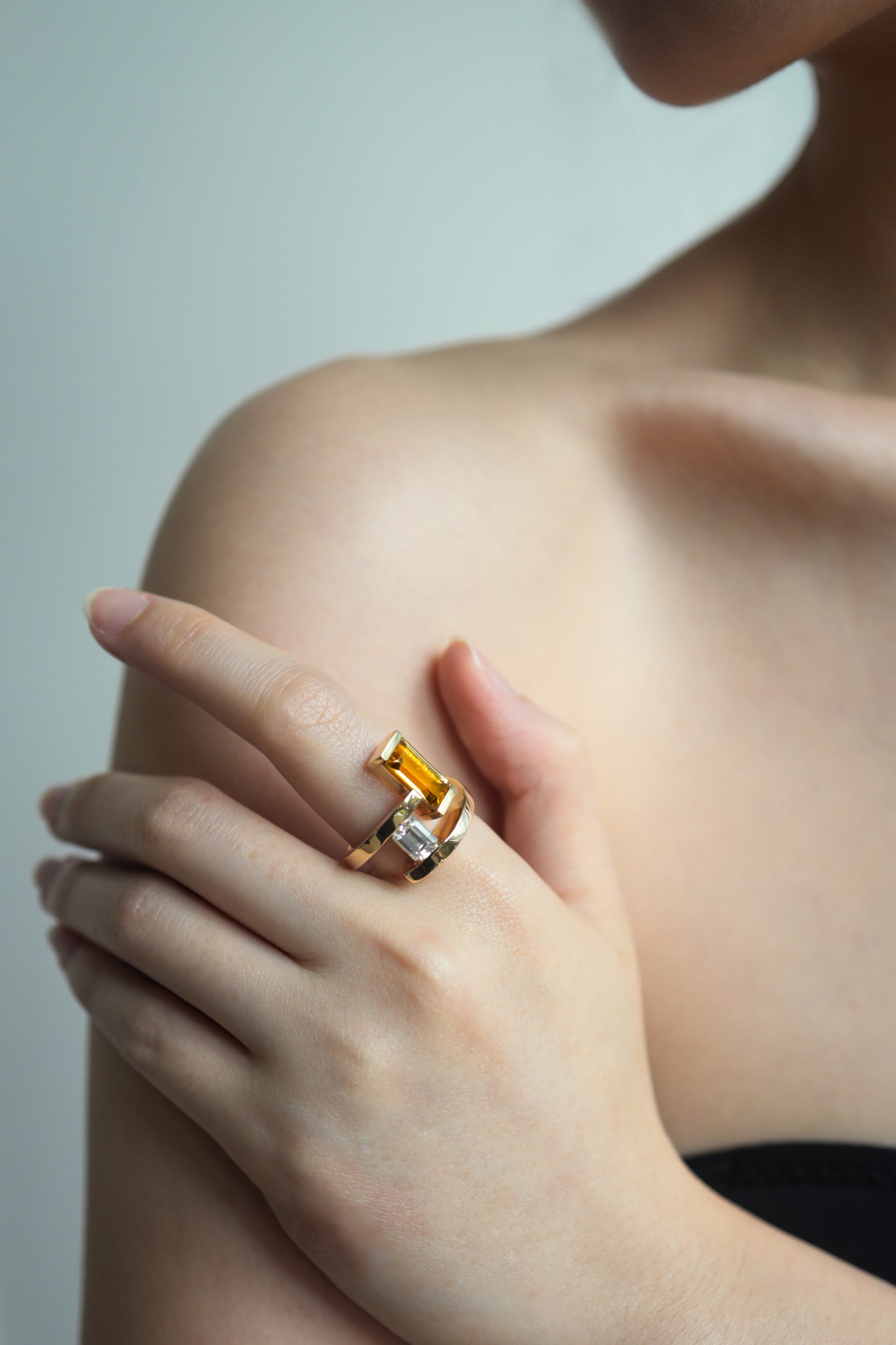 Elevé Yellow Emerald x Topaz Staircase Ring in 18k Gold, showcasing bold step-cut gemstones on a hand model.