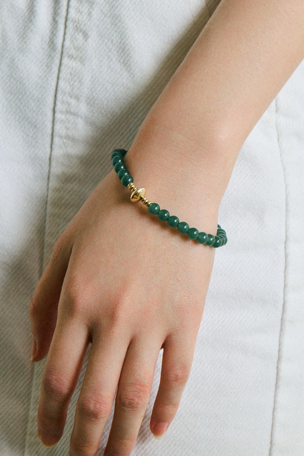 Hand wearing a Green Alloy Jadeite Bead Bracelet featuring jadeite beads and gold accents.