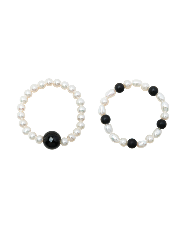 Moon & Midnight Obsidian & Pearl Ring Duo featuring pearl and obsidian rings in contrasting designs.