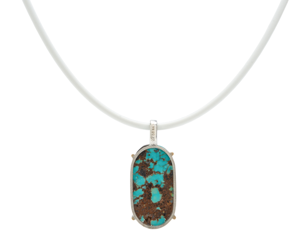 Handmade raw turquoise pendant featuring a Japanese stone, set on a simple white cord necklace.