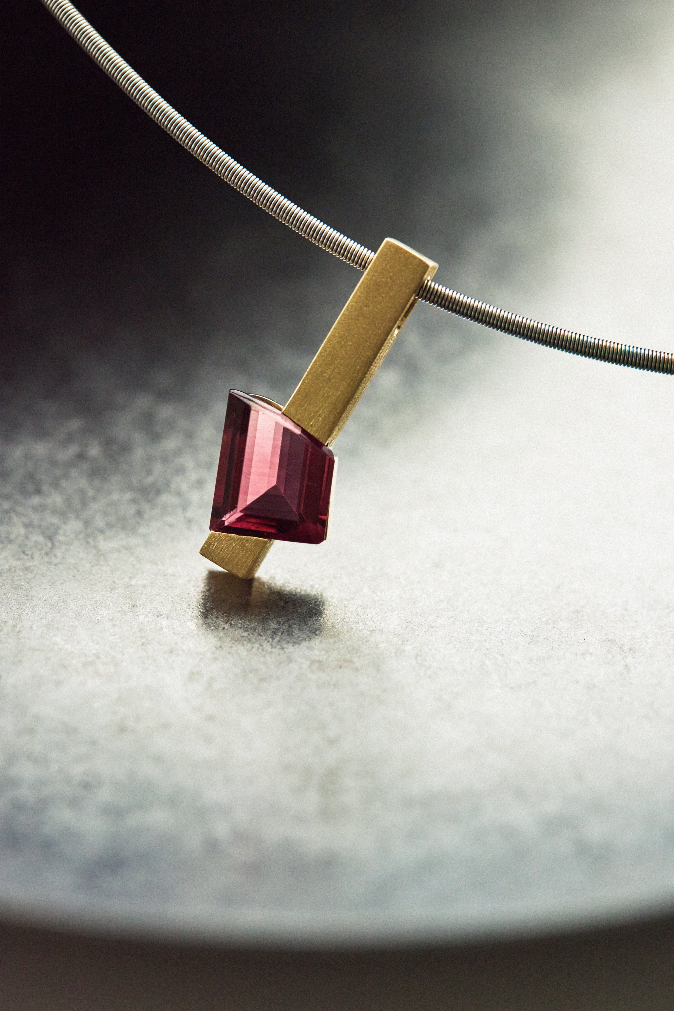 Jolly Tourmaline Rod Pendant featuring a fancy-cut tourmaline in rich hues, displayed on a sleek background.