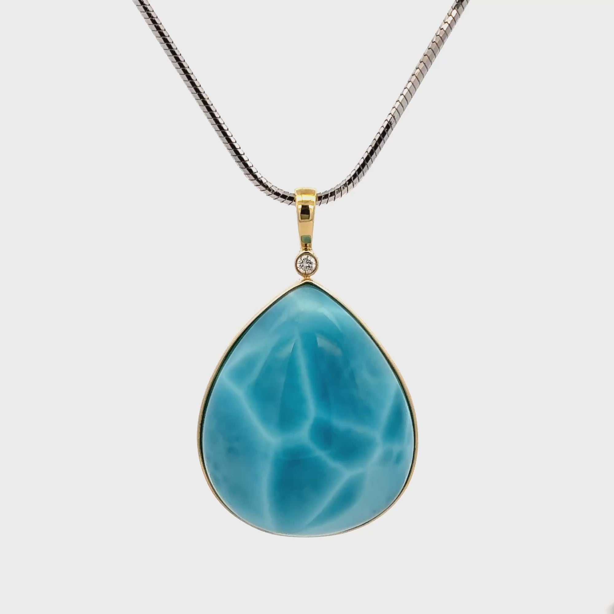 Larimar Pendant set in 18K gold with vivid ocean-blue gemstone