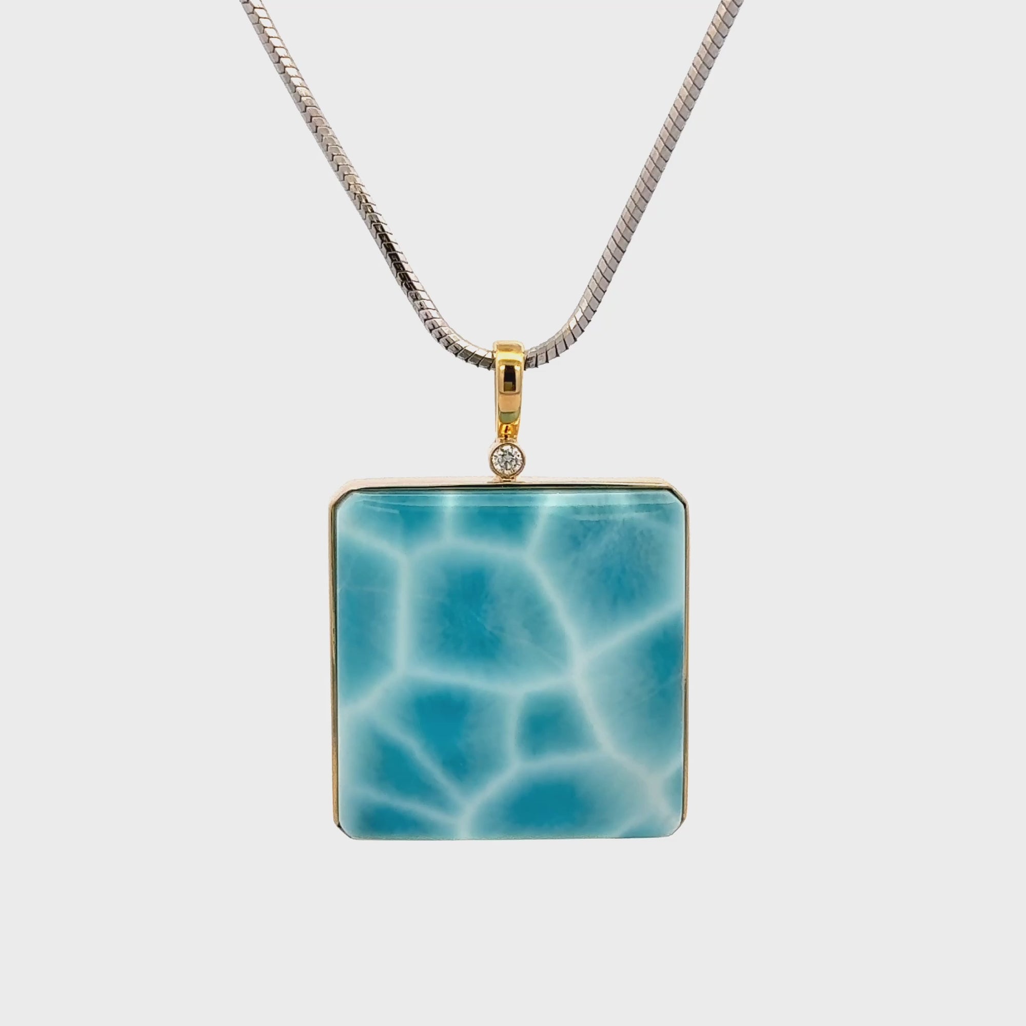 Larimar Pendant set in 18K gold with vivid ocean-blue gemstone