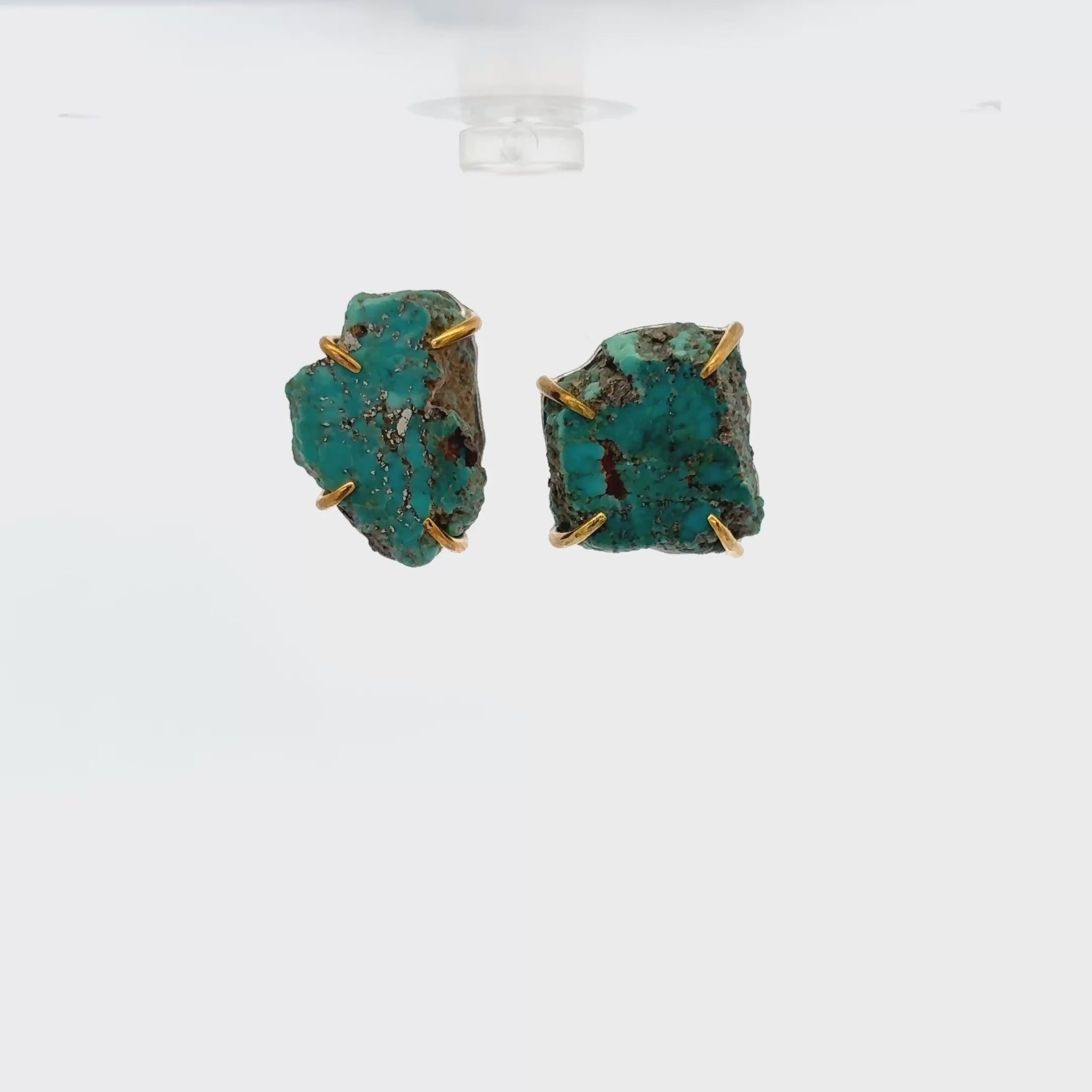 Handmade raw turquoise ear studs with gold claw settings, showcasing unique blue-green tones and natural beauty.