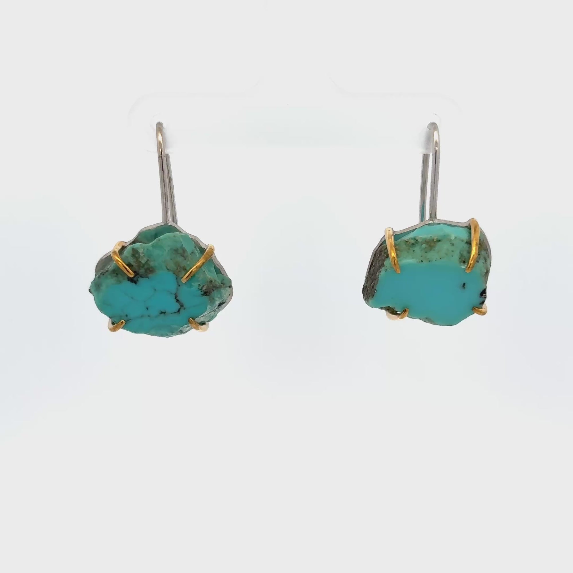 Raw turquoise handmade ear hook earrings with claw setting showcasing natural edges and organic beauty.