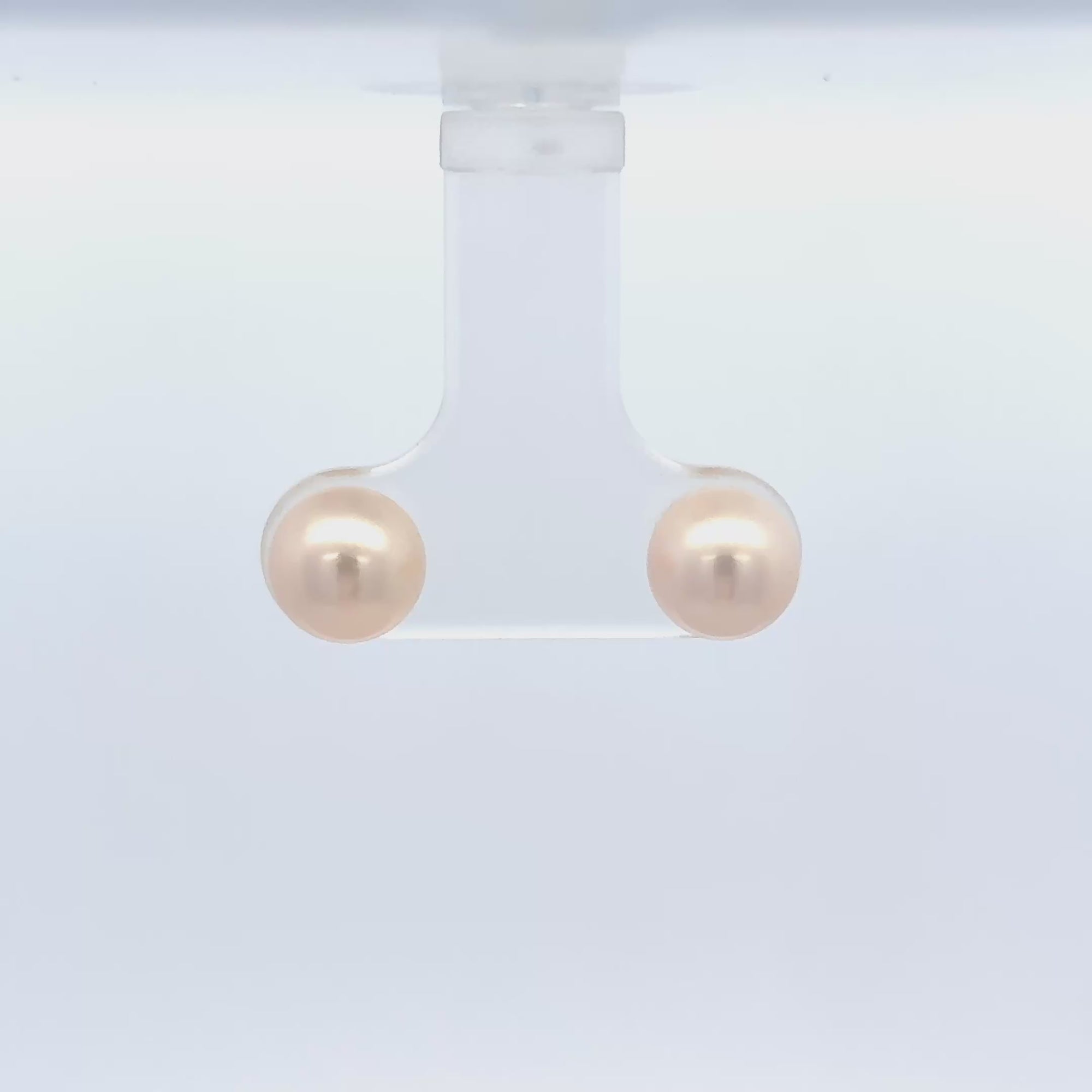 Akoya pearl ear studs in 18k gold, showcasing their lustrous elegance and classic design.